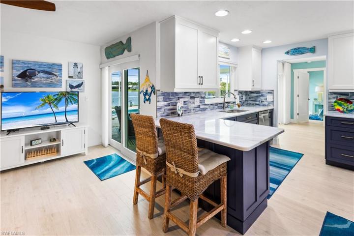Beautiful two toned wood cabinets with granite countertops and subway tile backsplash.