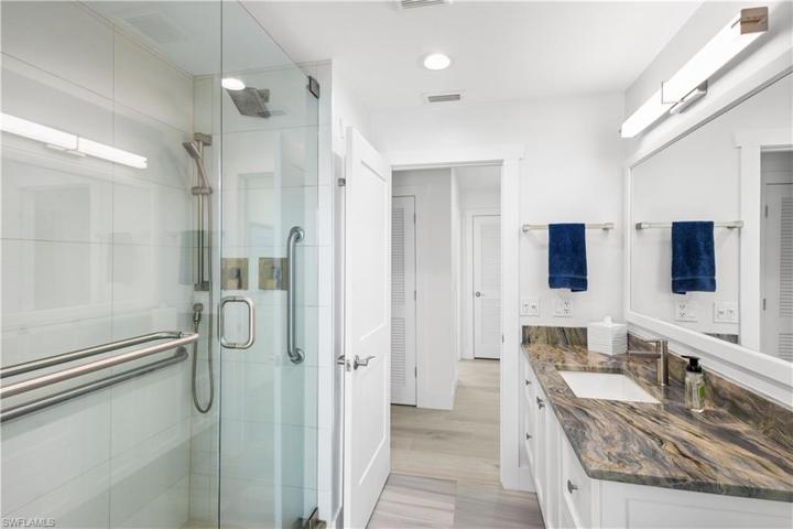 Remodeled 2nd full bath has walk in shower, single vanity and granite countertop.