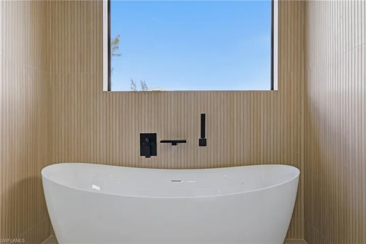 Bathroom featuring a freestanding bath and healthy amount of natural light