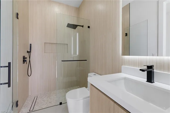 Bathroom with a tile shower and vanity