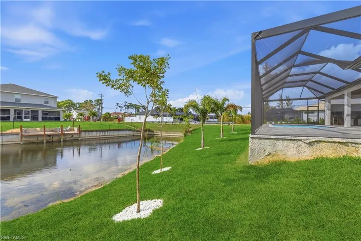 View of community featuring a sunroom, a water view, and a pool