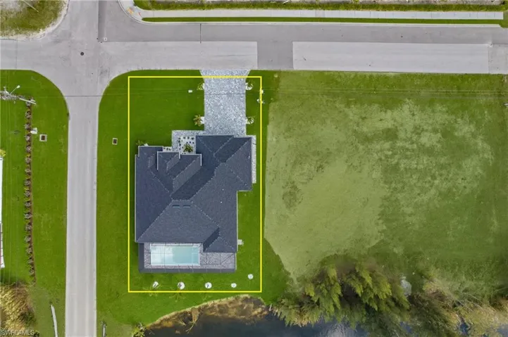 Aerial view of property and surrounding area featuring property parcel outlined
