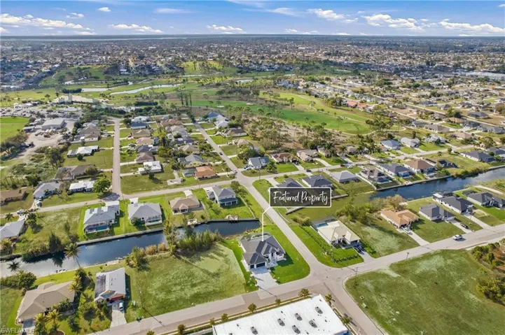 Aerial view of property's location with nearby suburban area and a large body of water