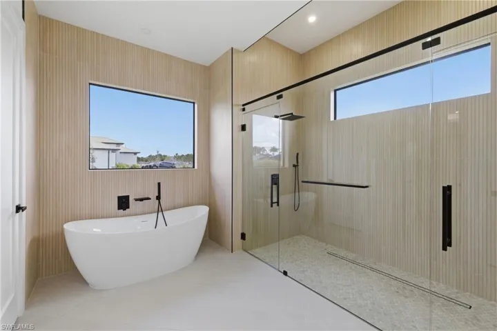 Bathroom with a stall shower and a freestanding tub