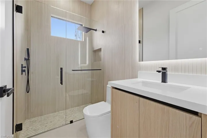 Bathroom with a stall shower and vanity
