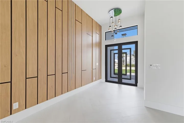 Entrance foyer featuring baseboards and a high ceiling