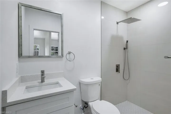 Bathroom featuring vanity and a shower stall