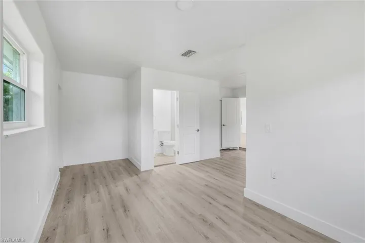 Unfurnished room with light wood-type flooring