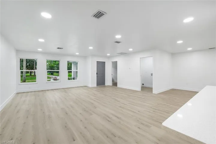 Unfurnished living room featuring light wood-style flooring and recessed lighting