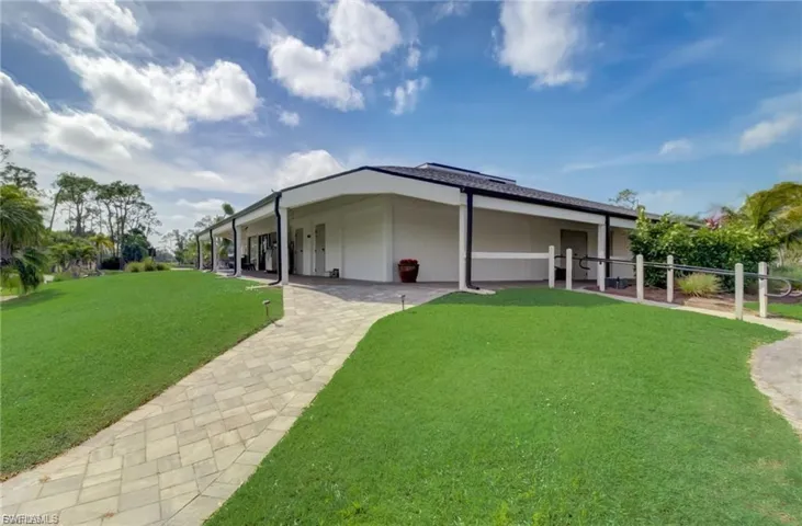 Back of house with a yard