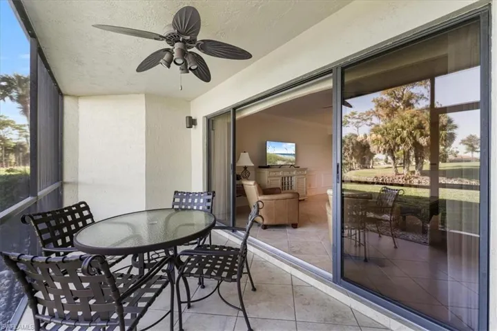 Sunroom with outdoor dining space and a ceiling fan