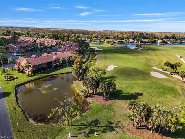 Aerial view of residential area with a large body of water and a golf course