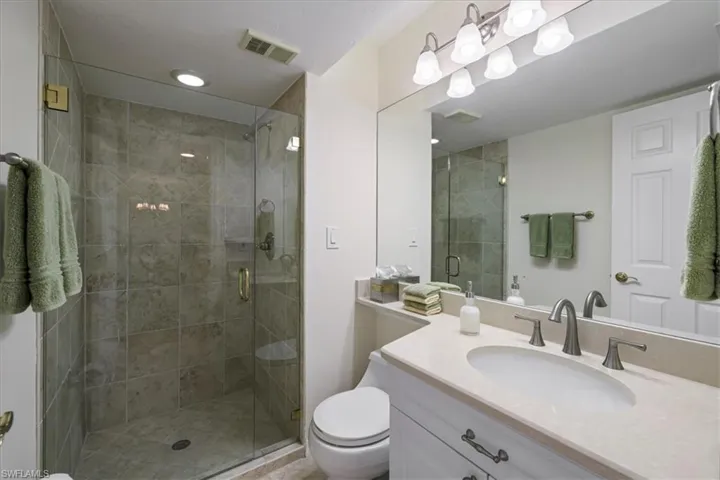 Bathroom with vanity and a stall shower