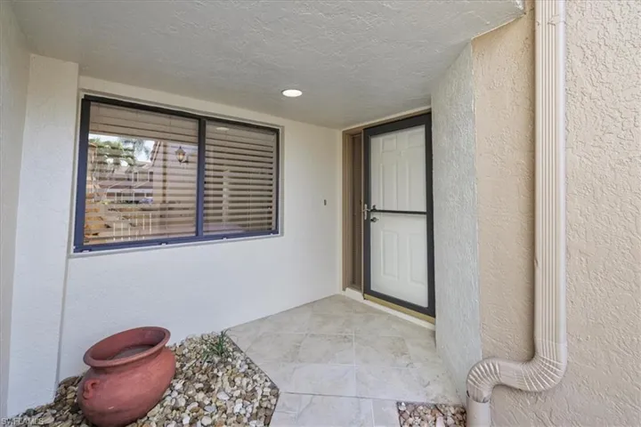 Property entrance featuring stucco siding