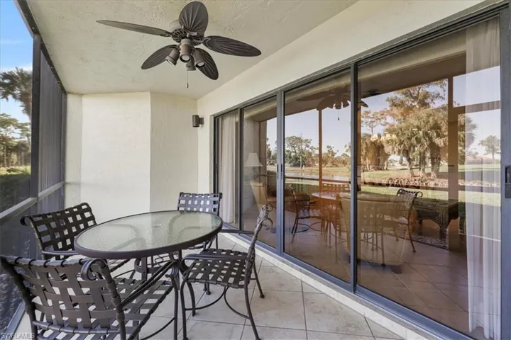 Sunroom featuring ceiling fan and outdoor dining space