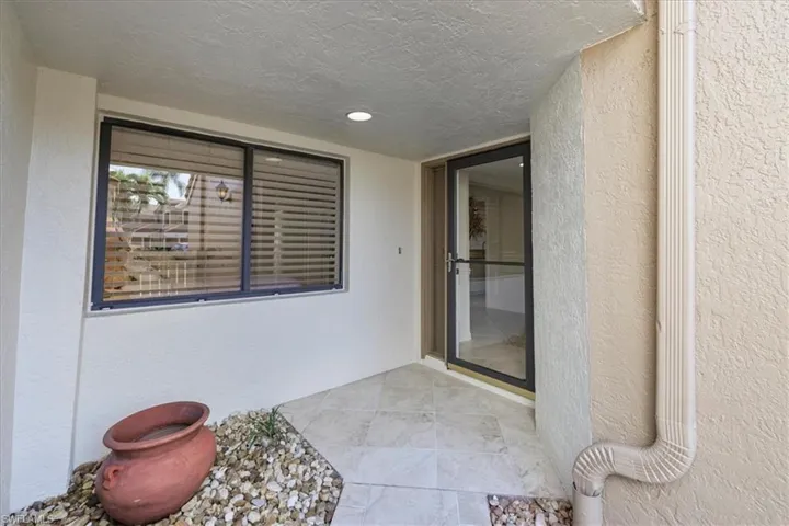 Entrance to property featuring stucco siding and a patio