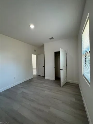 Unfurnished bedroom with light wood-style floors, a closet, and recessed lighting