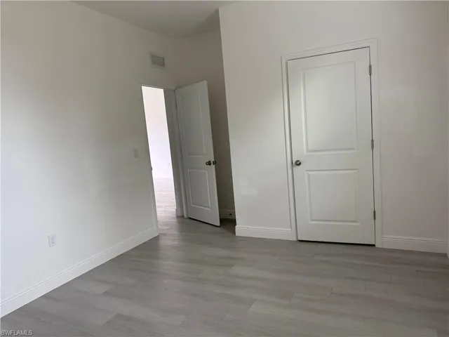 Unfurnished bedroom featuring light wood-style flooring and baseboards