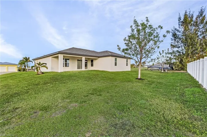 Rear view of house with a lawn