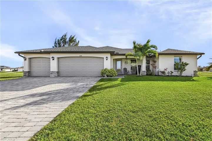 Ranch-style home with a garage and a front yard