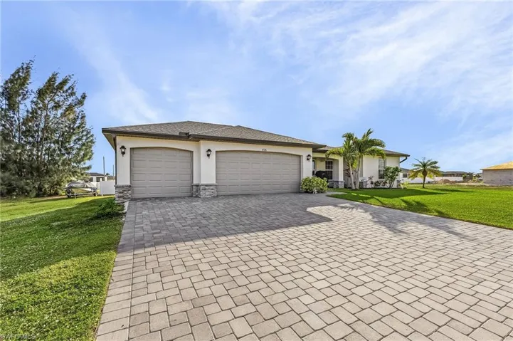 Single story home featuring a front lawn and a garage