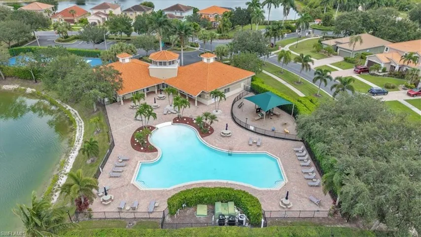 Bird's eye view of a nearby body of water and a pool