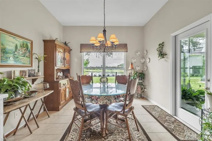 Dining area featuring light tile patterned flooring and a chandelier