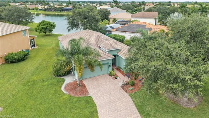Aerial view of residential area featuring a nearby body of water