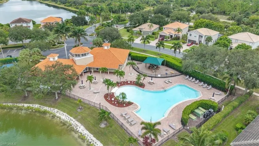Aerial view of property's location with a large body of water and a pool area