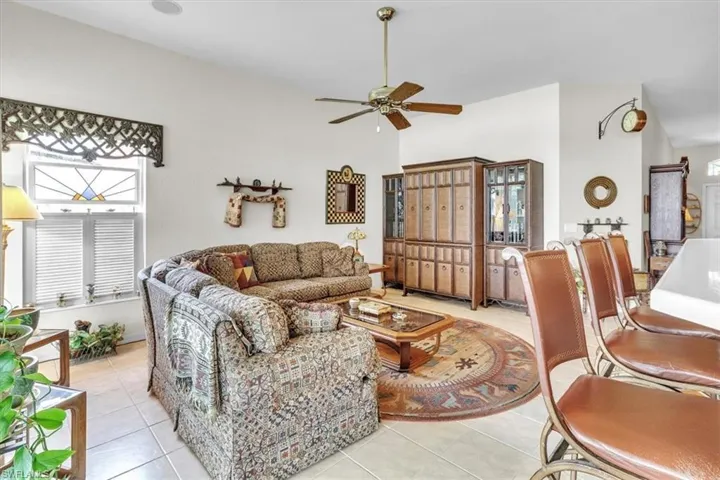 Living room featuring a ceiling fan and light tile patterned floors