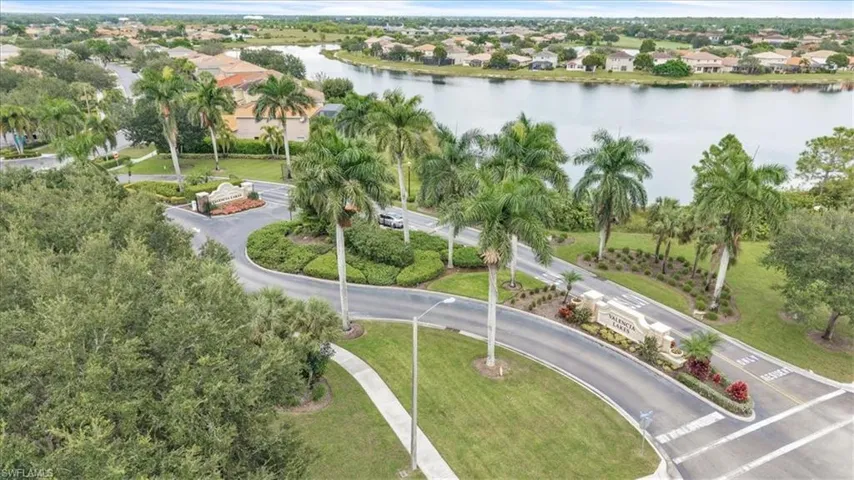 Aerial view of residential area featuring a nearby body of water