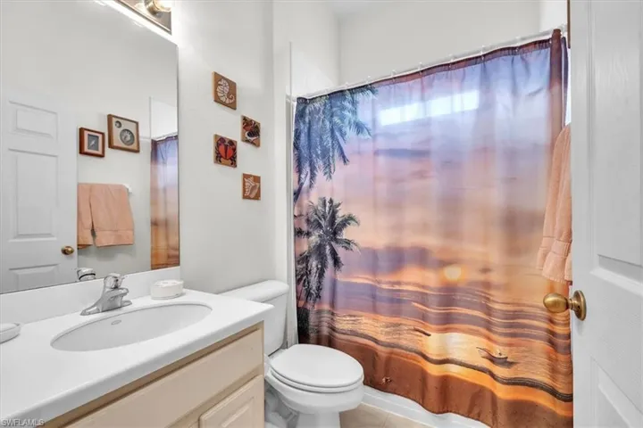 Full bathroom featuring vanity, a shower with shower curtain, and light tile patterned floors