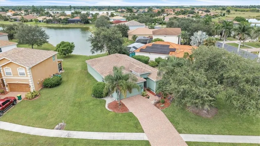 Aerial perspective of suburban area featuring a large body of water