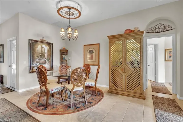 Dining room featuring light tile patterned flooring and a chandelier