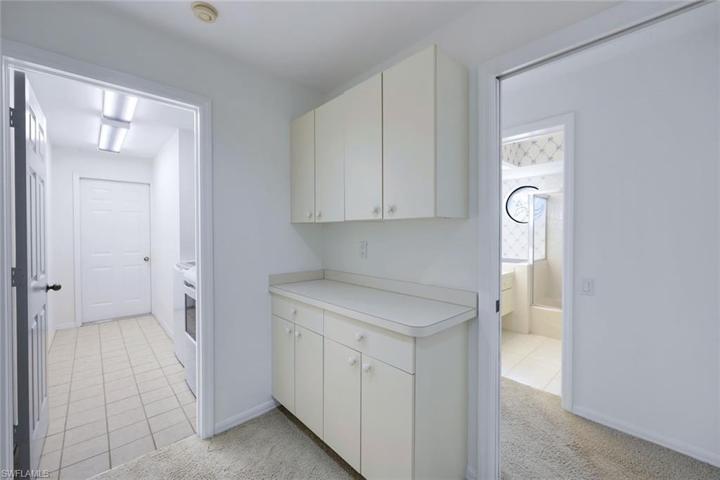 Hallway into Tiled Laundry Room- Entry into Attached Garage