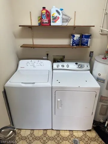 Laundry area with water heater and washing machine and dryer