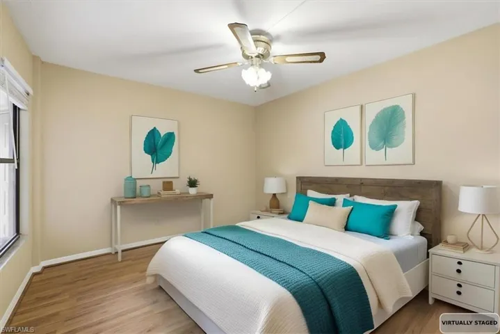 Bedroom with light wood finished floors and a ceiling fan