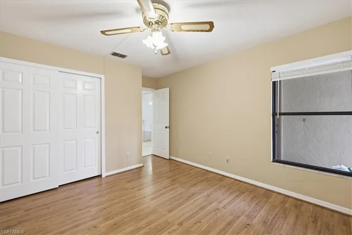 Unfurnished bedroom featuring a ceiling fan, light wood finished floors, and a closet