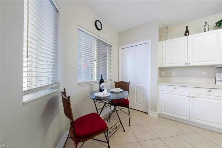 Dining area with light tile patterned flooring