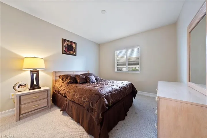 Bedroom featuring light colored carpet