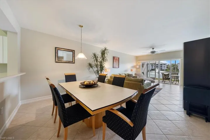 Dining room featuring light tile patterned flooring and ceiling fan