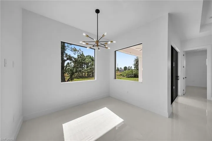 Unfurnished dining area with a chandelier and light tile patterned floors