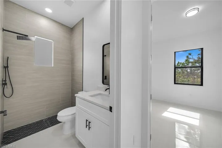Bathroom featuring vanity, a stall shower, and light tile patterned floors