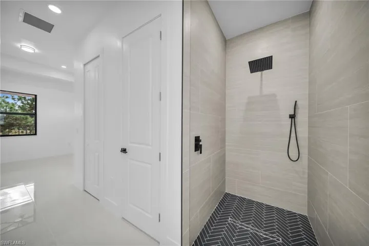 Full bath with a stall shower, recessed lighting, and tile patterned floors