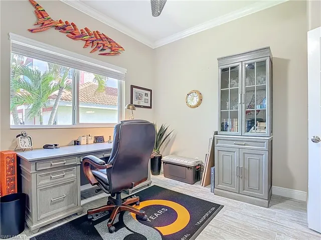 Office area featuring crown molding and light wood finished floors