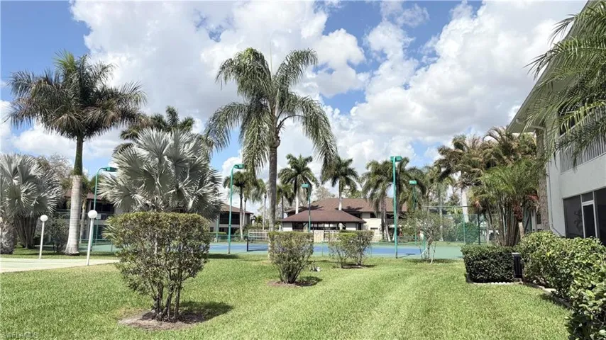 View of home's community featuring a tennis court