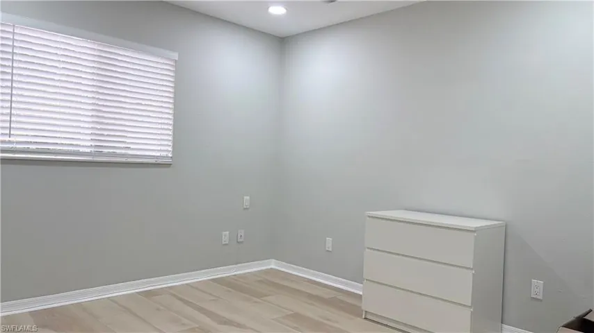 Empty room featuring light wood-type flooring and recessed lighting