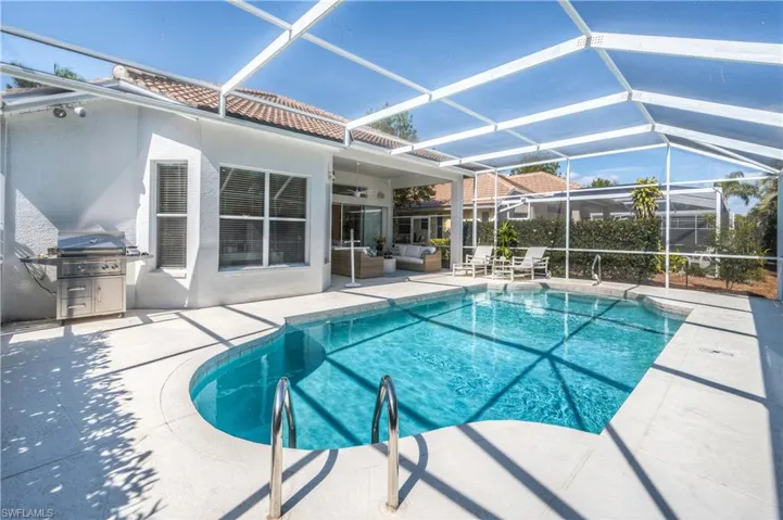 Pool featuring a lanai, a patio area, outdoor lounge area, and ceiling fan