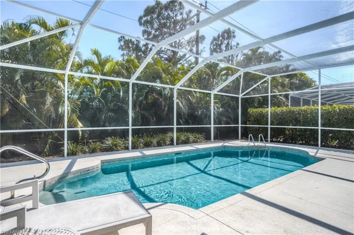 Outdoor pool with a lanai and a patio