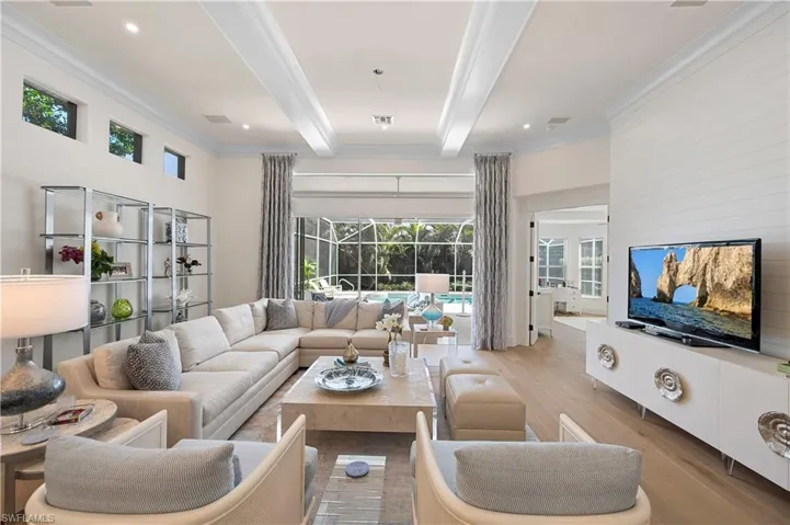 Living room featuring crown molding, visible vents, beam ceiling, recessed lighting, and wood finished floors